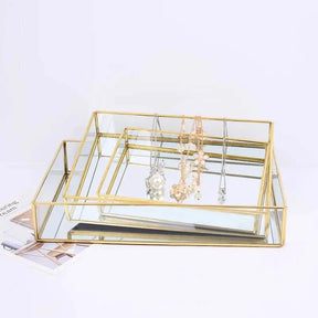 Luxurious Orter trays and box with brass and glass in gold finish for elegant organization.