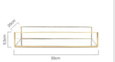 Luxurious Orter trays in brass and glass with gold finish, elegant home organization.