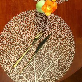 Ollie Placemats leaf design golden PVC table mats, set of four.